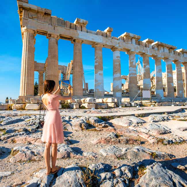 Young woman at the Acropolis in Athens - Luxury Travel Services by Travelive